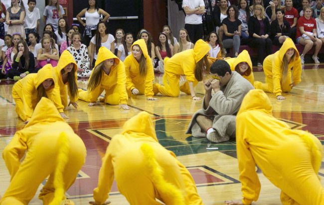 Senior LaRon Bullock sits in the middle of the gym while students dressed as lions creepy closer to him during the senior skit.