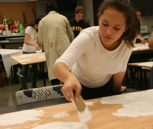 Sophomore Tara Antee paints one of the sets on Wednesday, Oct. 15. 