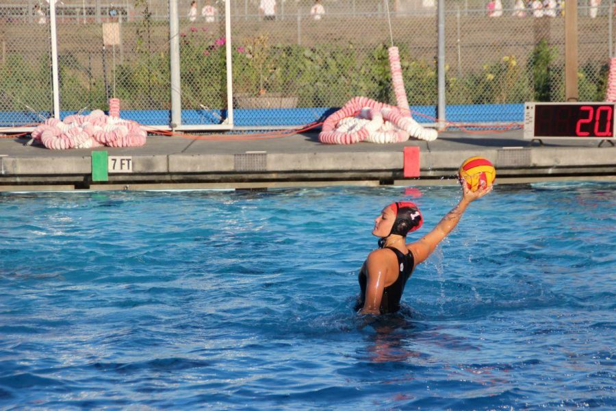 Junior goalie, Laurel Doyle throws the ball up the pool. 