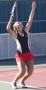 Junior Lauren Wolfe arches back, preparing to smack the serve over the net to her Drake opponent. 