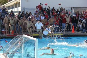 The entire team jumps into the pool, celebrating their victory. 
