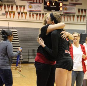 Sophomore, starter McKenzie Cooke hugs her coach after being given a NCS medal. 