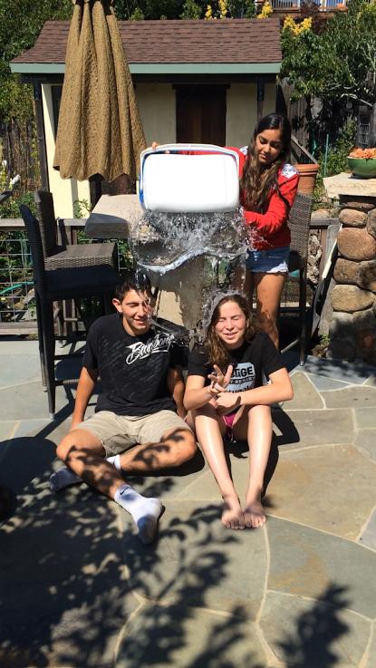 SENIOR KISMET KUMAR dumps water on seniors  Jacob Zazzeron and Molly Moritzburke for the Ice Bucket Challenge.  