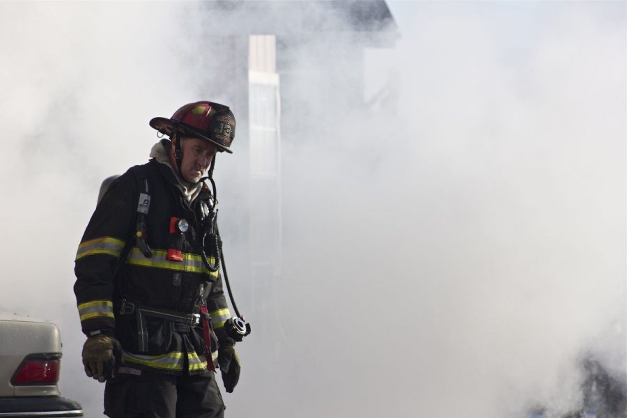 A firefighter walks away from the flames.