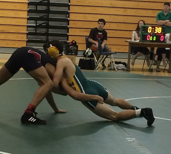 Varsity athlete spars against opponent at first league tournament of the year.