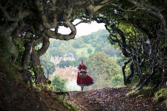 Little Red Riding Hood, played by Lilla Crawford, skips ‘Into the Woods’ while singing the film’s title song