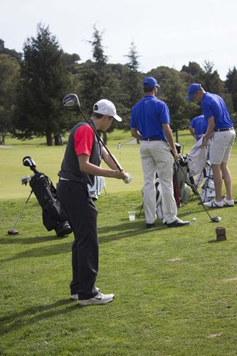 Junior Nick Laub practices his swing before teeing off on the first hole of the match on Thursday, March 12.
