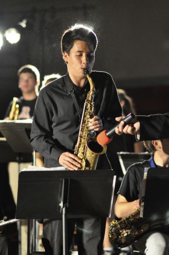 Senior Evan Miawaki stands up for a solo in the big gym during the wind ensemble