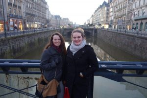 Celebrating New Year's Eve, sisters Taylor and Delaney Benstead overlook the town of Rennes, France from a bridge. 
