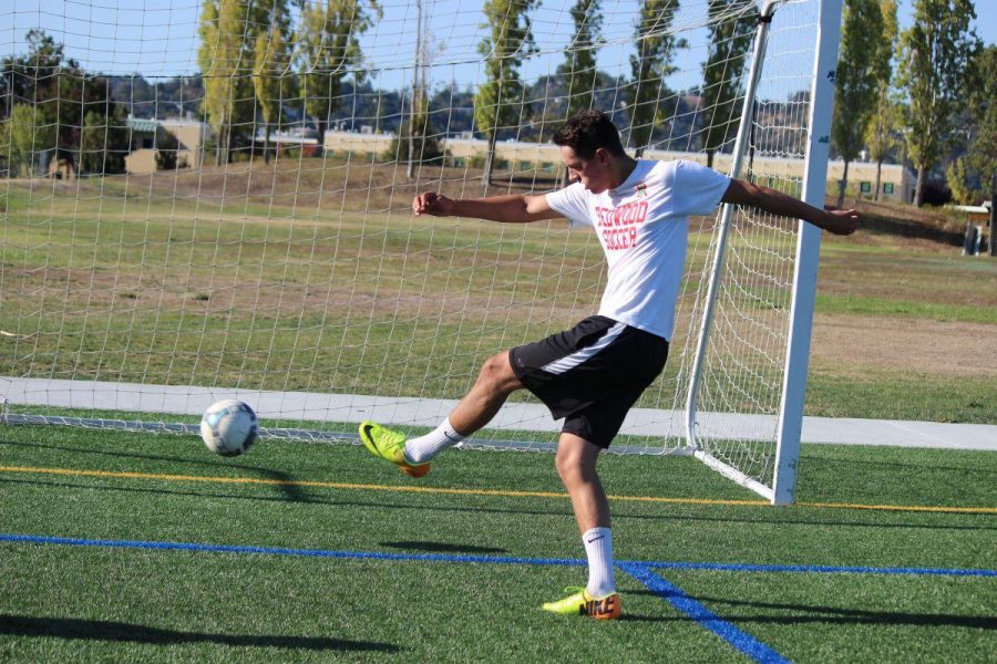 Senior Jack McClean volleys a shot on goal in a preseason training session. In previous years, the boys soccer season would be underway at this point.