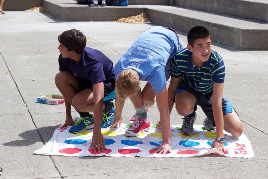 Freshmen Gabe Johnson, Miles Dean, and Nathan Kim (from left to right) play Twister during a Link Crew mini event on Friday, Aug. 28.