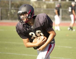 Junior Nick Desaurnauts does a ball security drill during practice.