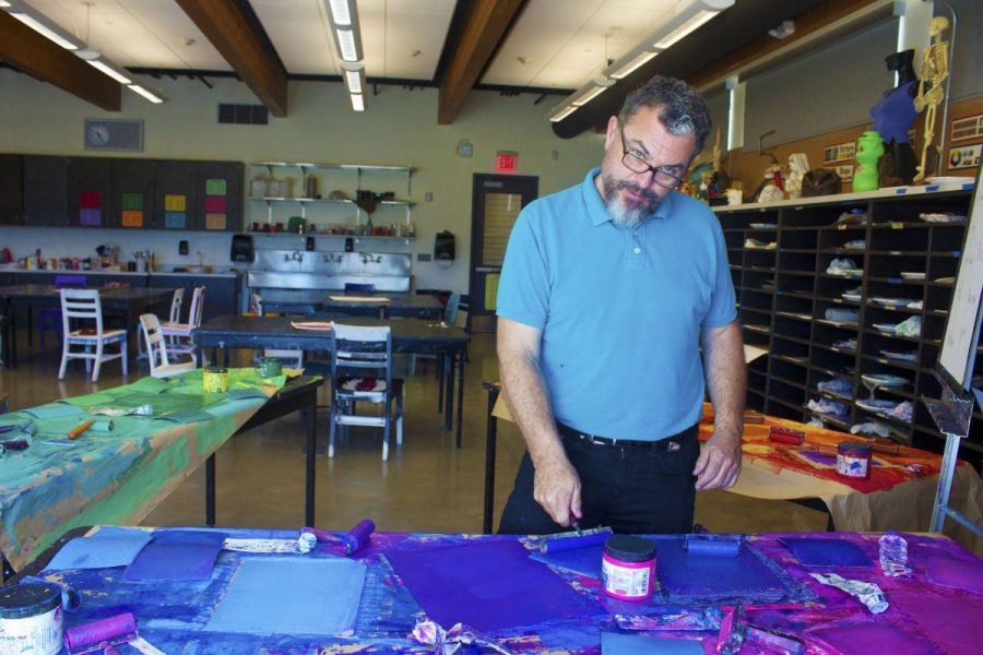 Douglas Dammarell, the new art teacher, poses in his classroom.