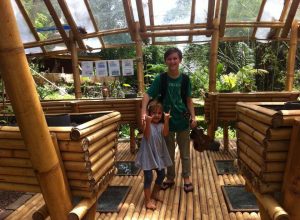 Freshman Sam Jackson stands with a preschool student inside of Green School in Bali, Indonesia. Jackson spent last year at this school studying sustainable living. 