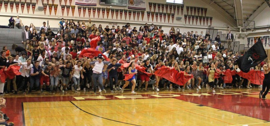 Seniors run down the bleachers for the presentation of the Class of 2016.