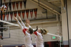 Junior Mckenzie Cooke (left) and senior Marguerite Spaethling attempt to block the volleyball in their game against San Rafael.