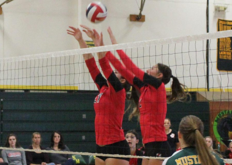 Sophomores Alex Lefebure and Chiara Ancona jump to block the ball off a hit from a San Marin player.