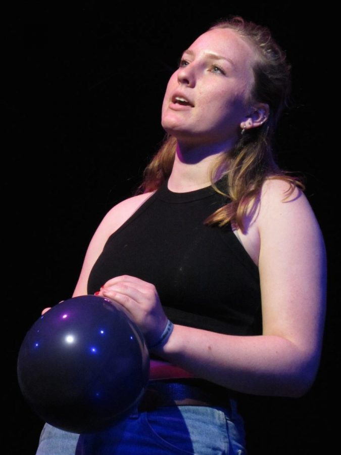 Clenching a black balloon, junior Kate Kiehfuss recites an original slam poem for the upcoming Advanced Drama production In a Nutshell. 