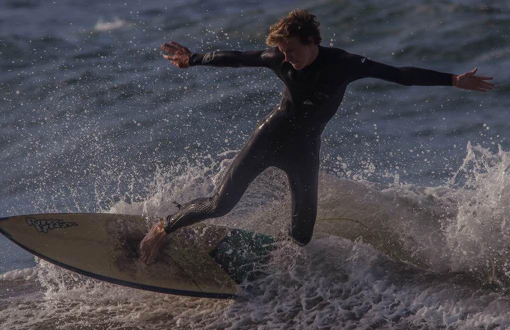 Senior Cale Smith drops in to a wave, while surfing at  Fort Cronkhite.