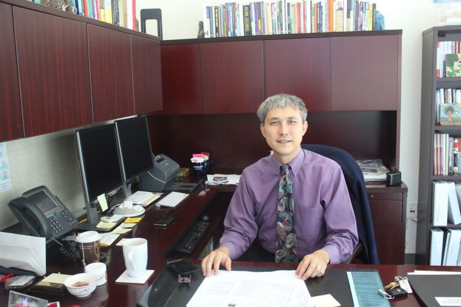Dr. David Yoshihara sits in his new office.  