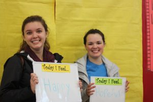 Seniors Ruby Rawlinson and Delaney Benstead pose with whiteboards that listed their feelings at lunch on Thursday, Dec 3.