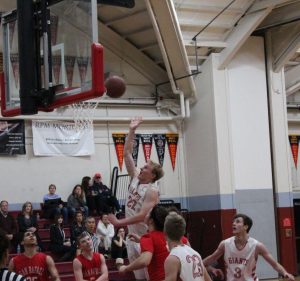 Junior Charlie Reis makes a contested layup to tie the game at 46.