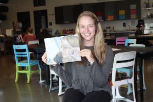 Bjursten poses with the drawing that won her the Silver Key Award. 