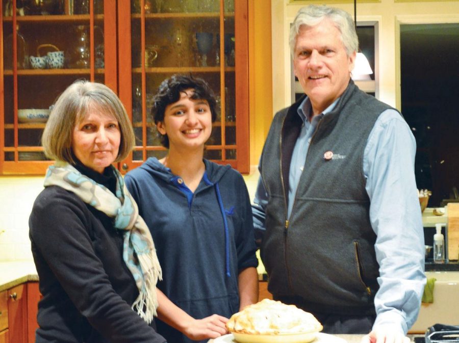 Sophomore Aru Kundhardt smiles  with her parents, Susan and David 