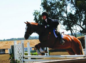 Jumping her horse, junior Grace Walker was ranked 11th in California when she was 13 years old.