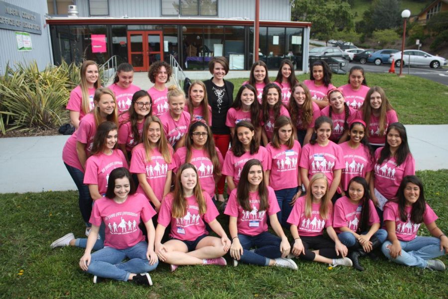 POSING WITH THEIR keynote speaker, ambassadors from the Marin Teen Girl Conference prepare for a day of empowering other girls to “be their own superhero.”