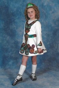 Halloran poses in her dancing attire at a young age.