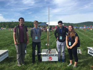 (from left to right) Senior Kevin Makens, Juniors Filip Platek, Joseph Alavi, Ashlyn D’Orazio stand next to their handmade rocket on May 14 in the Plains, VA at the launching site. 
