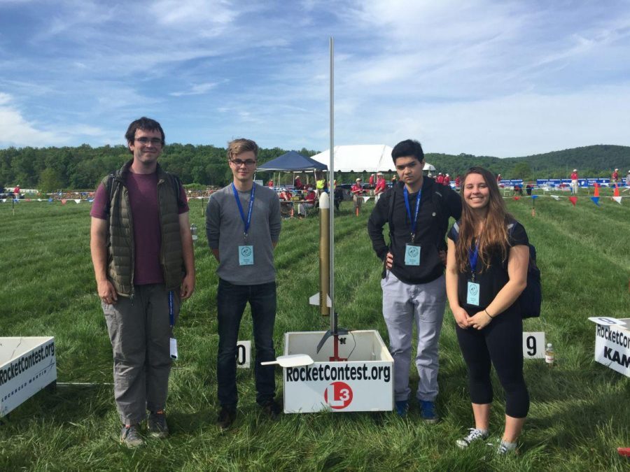 (from left to right) Senior Kevin Makens,  Juniors Filip Platek, Joseph Alavi, Ashlyn D’Orazio stand next to their handmade rocket on May 14 in the Plains, VA at the launching site. 
