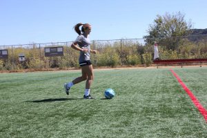 Practicing for the upcoming season, Lauren Foehr kicks the ball down the field.