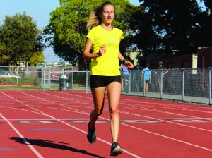 ARRIVING FROM ITALY, senior Chiara Visintini runs during cross country practice. Visintini has impressed her coaches and teammates with her work ethic.