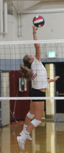 Senior setter Mari Molina leaps to make a one-handed set during practice.
