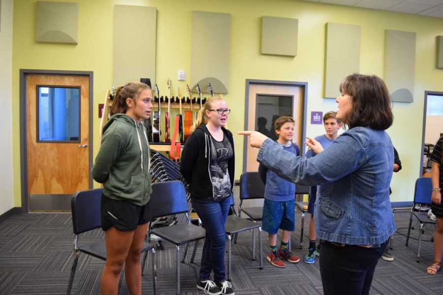 Leading chorus students in vocal exercises and song covers with multiple harmonies at the second chorus class, Martone teaches a program that is open to students of all grade levels and meets on Thursday nights.