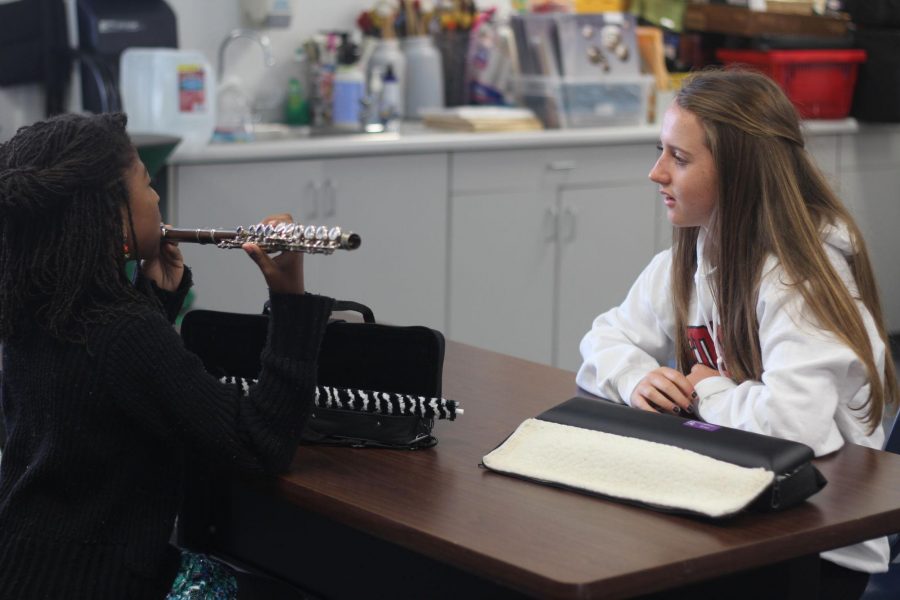 Teaching flute lessons to students at MLK-Bayside Middle School on a Saturday morning, freshman Emily Comins volunteers at the Sound Waves Program.