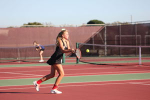Sophomore Lilly Blanadet prepares to hit the ball in final match of the season before playoffs