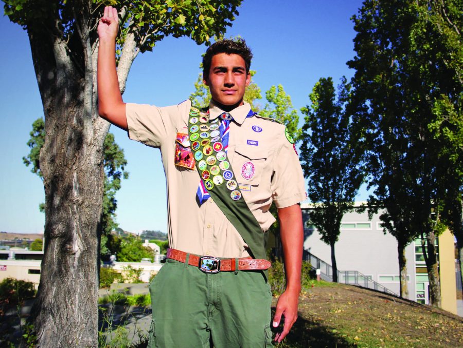 Senior Wyatt Barker holds up his hand in the Boy Scout three-fingered salute.
