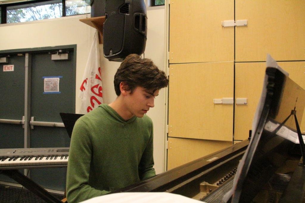 Playing the piano, senior Parker Addison practices the songs within his album while in the Advanced Performance Workshop classroom.
