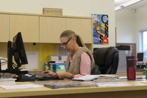 Meg Heimbrodt working at her desk in the College and Career Center, as in her new role as College and Career Counselor.