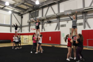 Preforming the routine, the 12 girls practice a stunt.