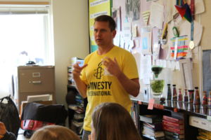 A member of Amnesty International talks to the club during their meeting on Thursday.