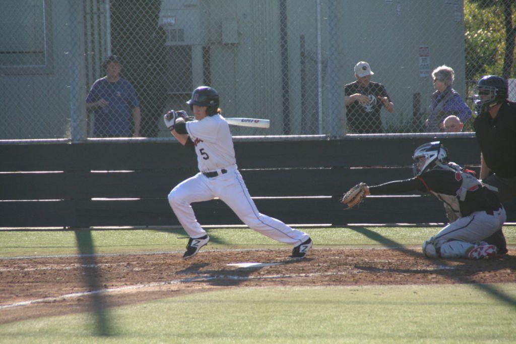 Senior Henry Zeisler finishes his swing after a base hit.