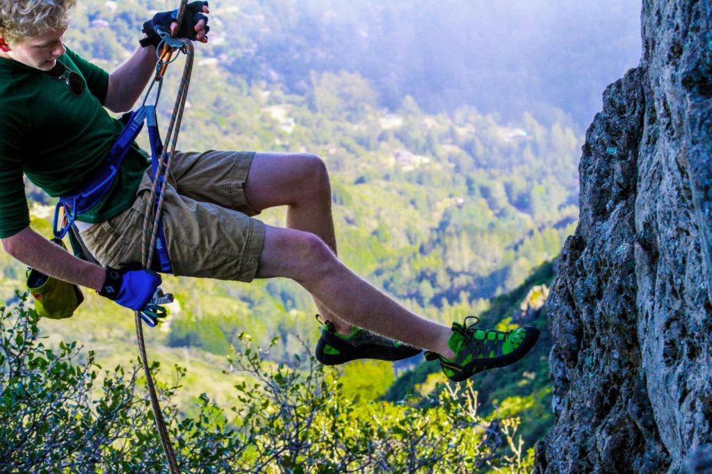 Sophomore Niklas Korn rappels down a steep cliff.