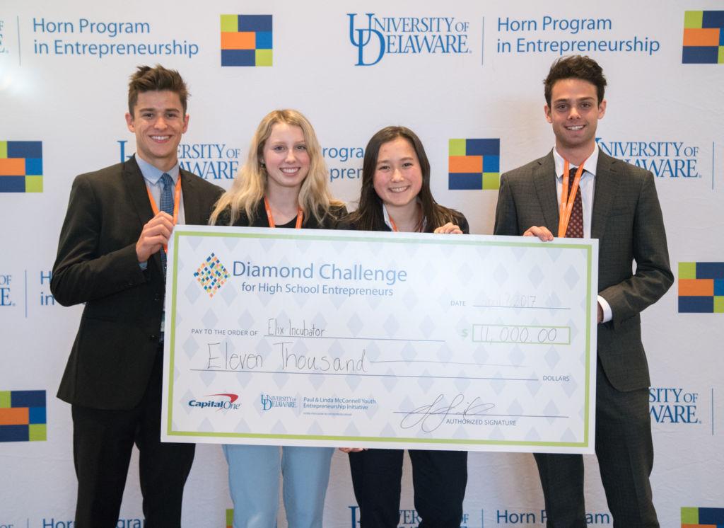 Receiving their $11,000 check for first place, four members of the Elix team represented their start-up at the Diamond Challenge.