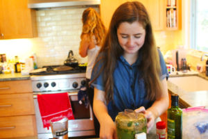 Using basil, walnuts, and olive oil, Fogarty blends her homemade pesto.