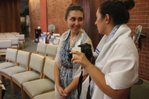 Senior photographers Angelica Vohland (left) and Katie Levy (right) take photos in their local synagogue for 'Women Facing West.'