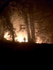 A firefighter battles a raging fire in Northern California.